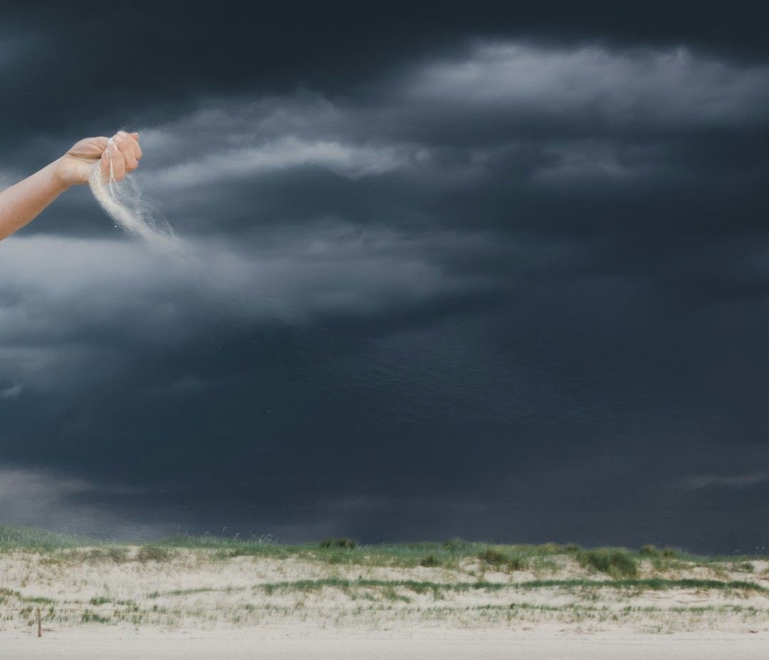 a woman is flying a kite on a cloudy day