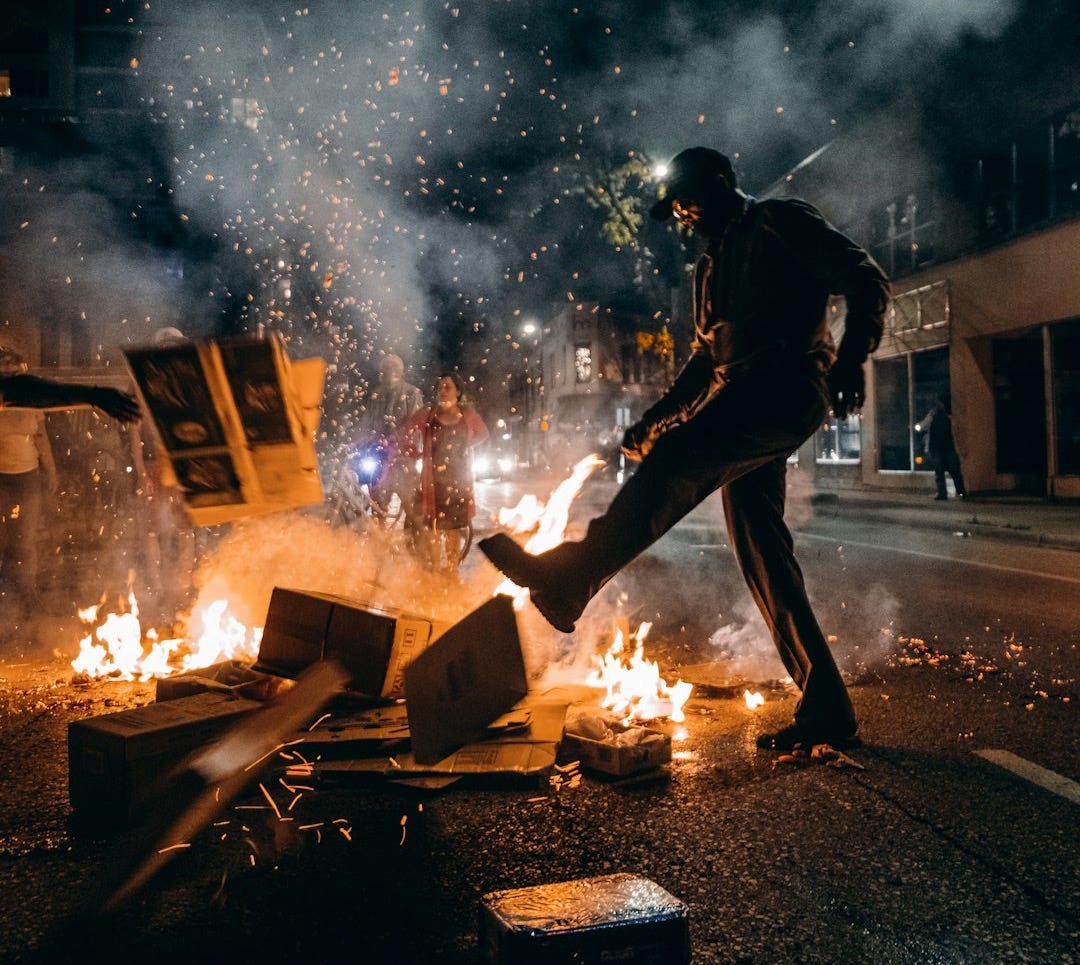 man in black t-shirt and black pants holding fire man in black t-shirt and black pants holding fire
