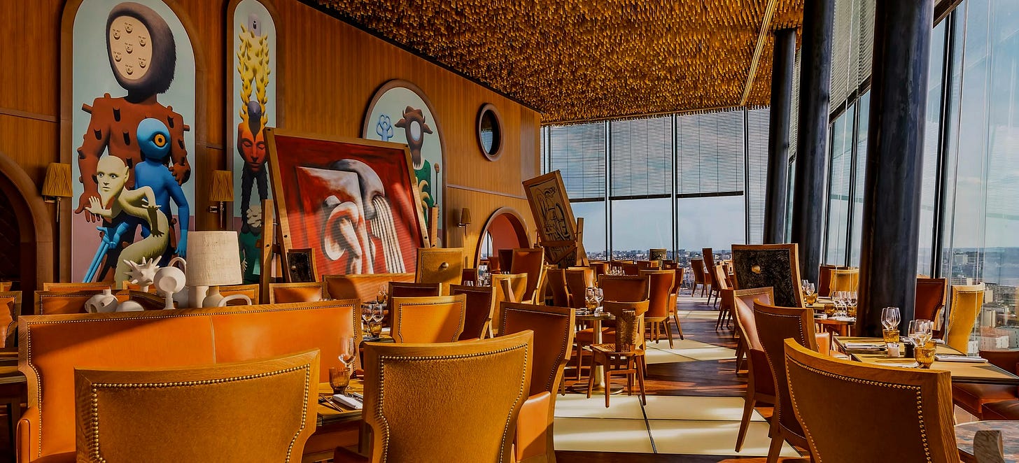 Photo of the main dining room at Too Restaurant showing the panoramic view of Paris.