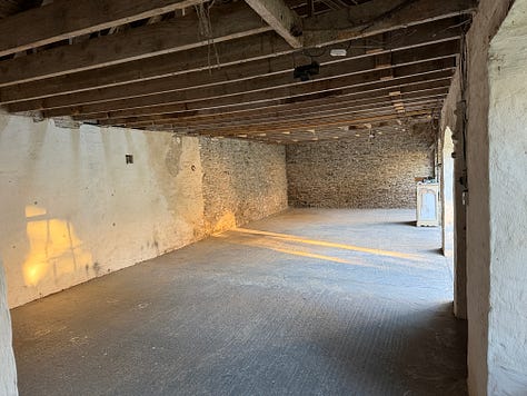 Three photos of an old barn with arched doors and light streaming in.