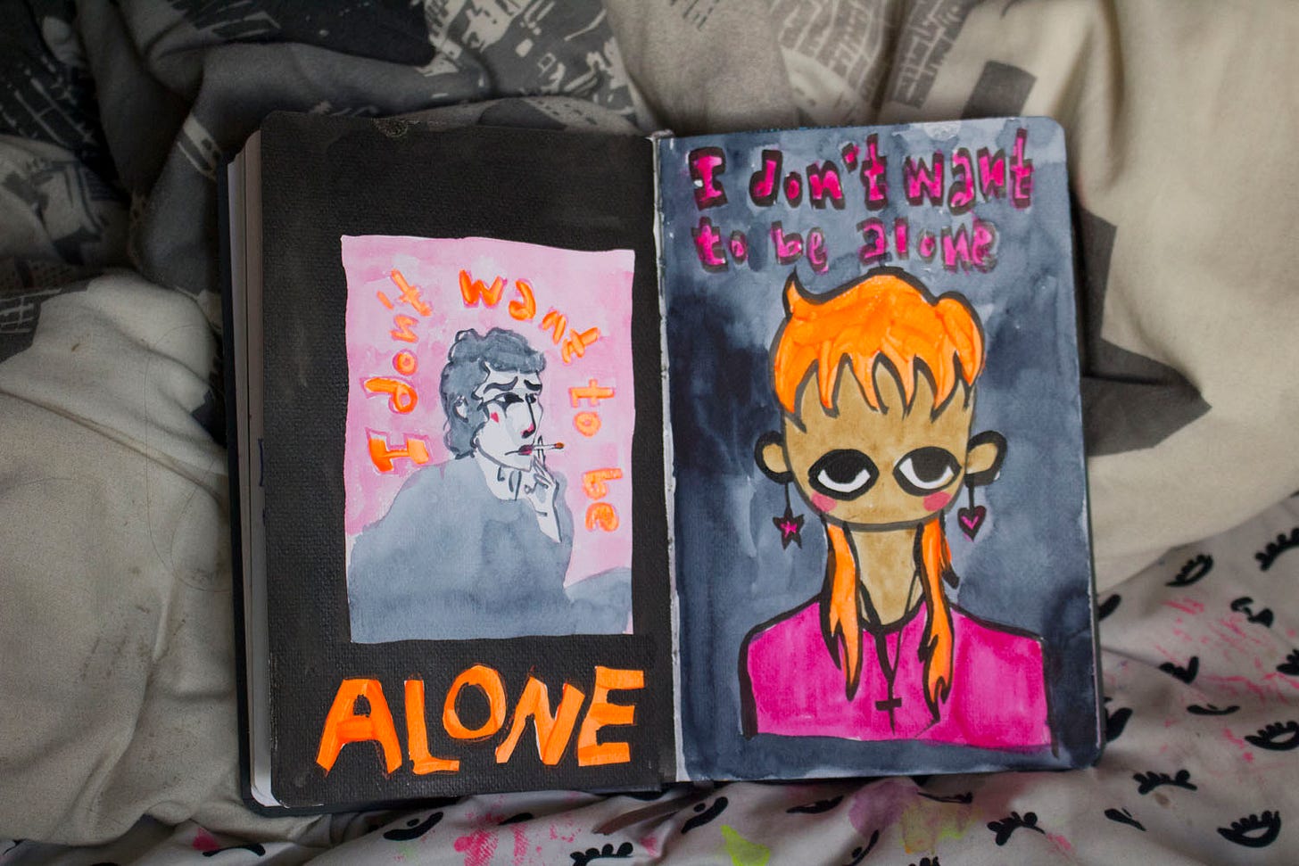 two paintings in orange, pink, and black featuring a guy smoking and a person looking up. they both have the text "i don't want to be alone."