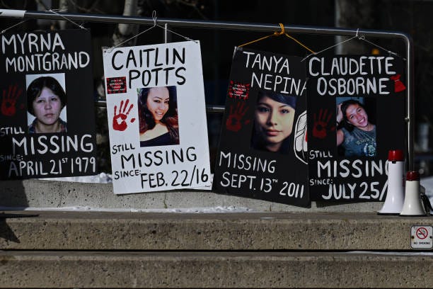 Images of missing and murdered Indigenous women and girls from the Edmonton area are displayed during a rally on International Women's Day at...