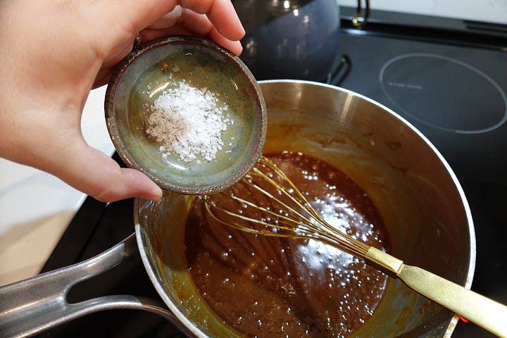 Watching the sugar melt before stirring in cream, butter, tahini, rose water, and a sprinkle of flaky sea salt.
