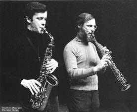 A couple of men playing saxophones

AI-generated content may be incorrect.
