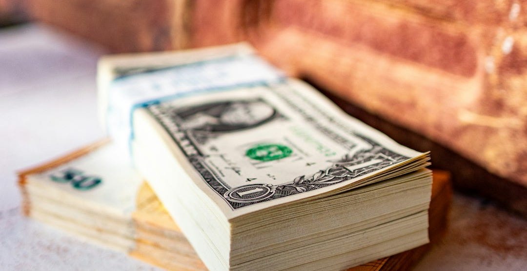 a stack of money sitting on top of a table