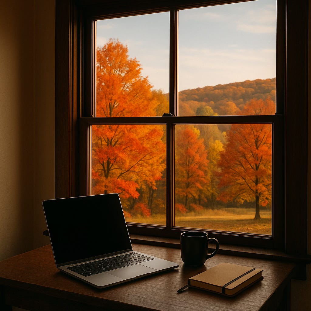 A laptop, notebook, and coffee mug on a wooden desk beside a window with a view of autumn trees and hills in Eastern Pennsylvania, glowing in morning sunlight. A laptop, notebook, and coffee mug on a wooden desk beside a window with a view of autumn trees and hills in Eastern Pennsylvania, glowing in morning sunlight.