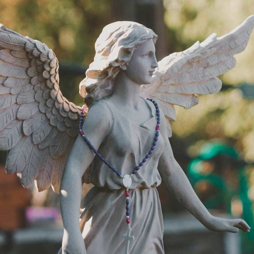 a statue of an angel holding a string