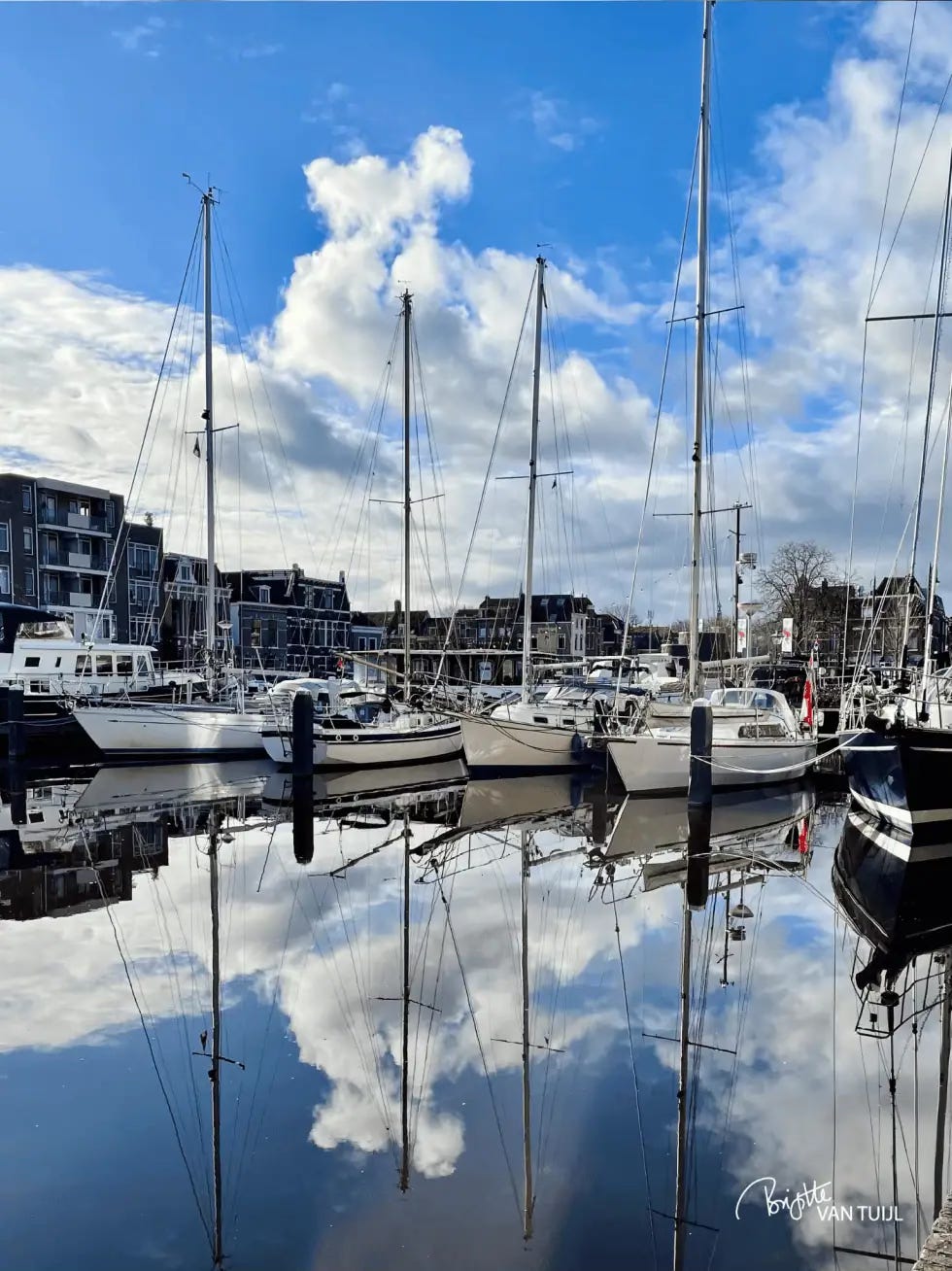 Boats in the harbor, reflected in the water Boats in the harbor, reflected in the water