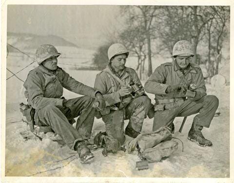 A mortar squad from Co E, 2nd Ann, 8th Infantry Regiment, 4th Infantry Division, taking a brief respite for a meal near Bettendorf, Luxembourg, January 21, 1945.