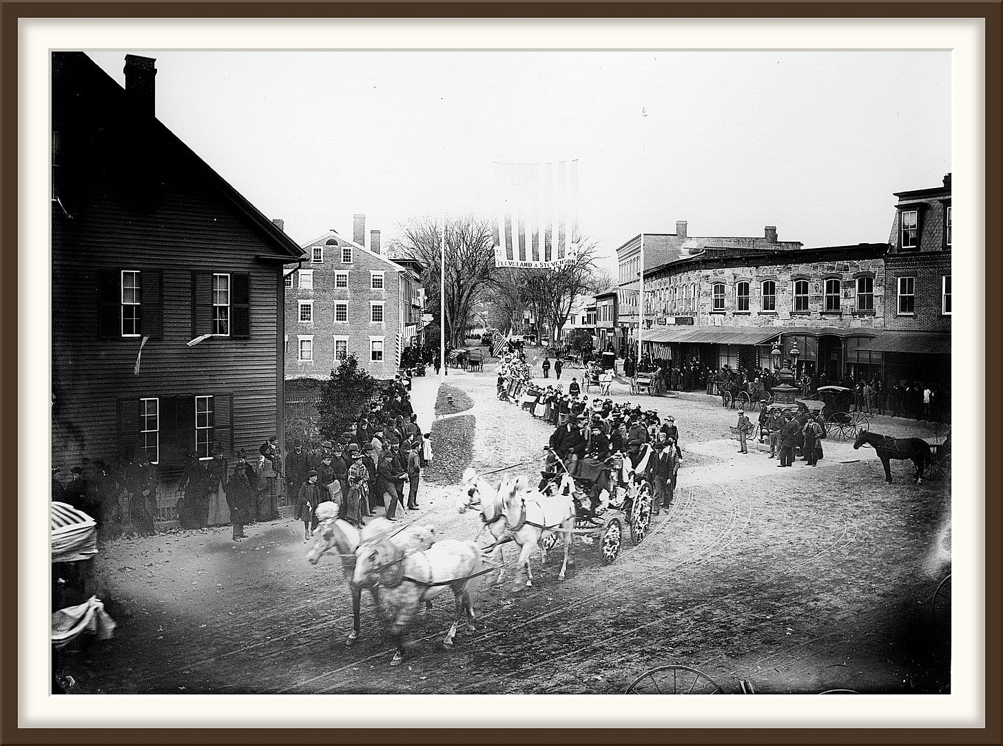 Columbus Day parade on Elm Street, Woodstock, Vermont, 1892: a four-horse coach, schoolchildren with flags, and a Cleveland and Stevenson banner