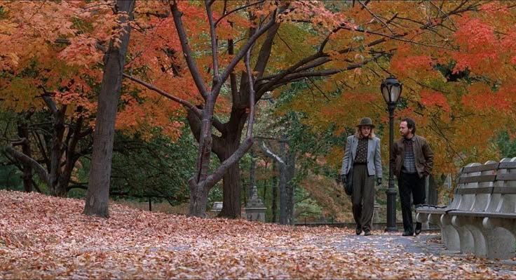 This may contain: two women walking down a path in the fall
