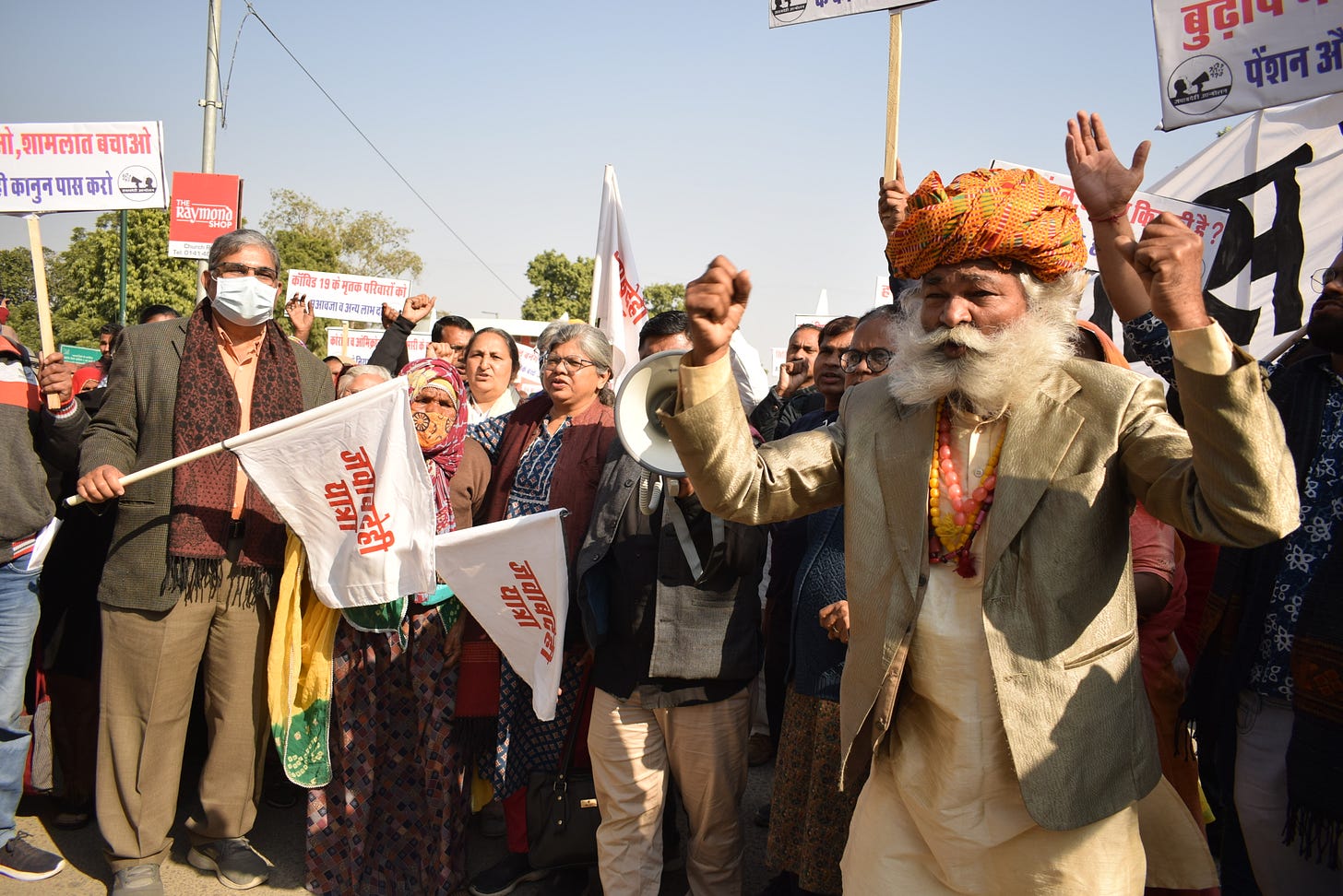 A group of people on a road, protesting for their rights