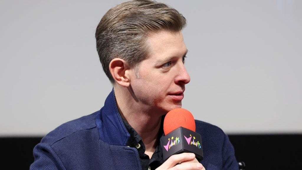 Sean Fennessey holding microphone