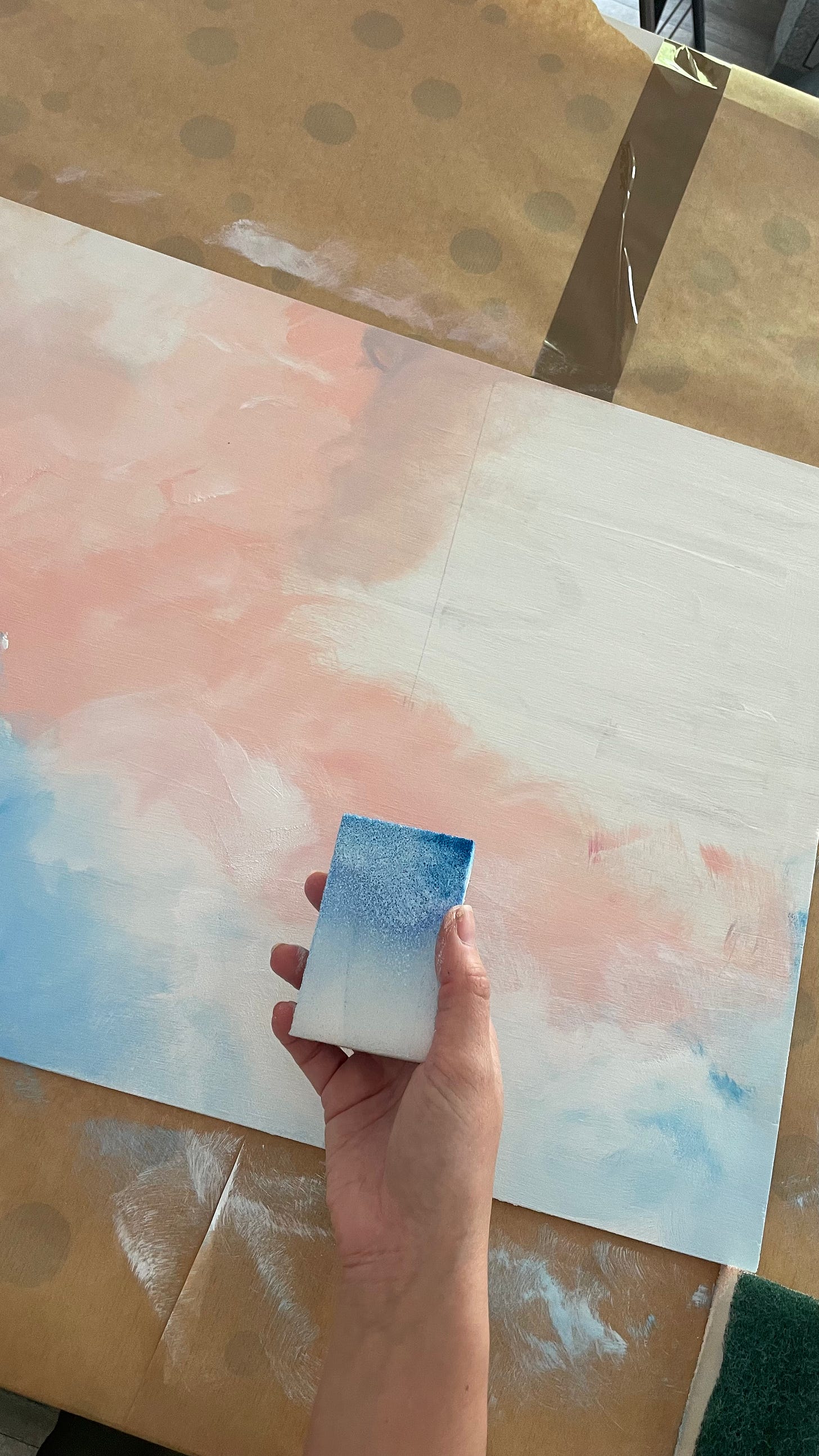 Fine art painting, with soft swirls of pastel pink, white and blue acrylic paint. Textures made with a sponge