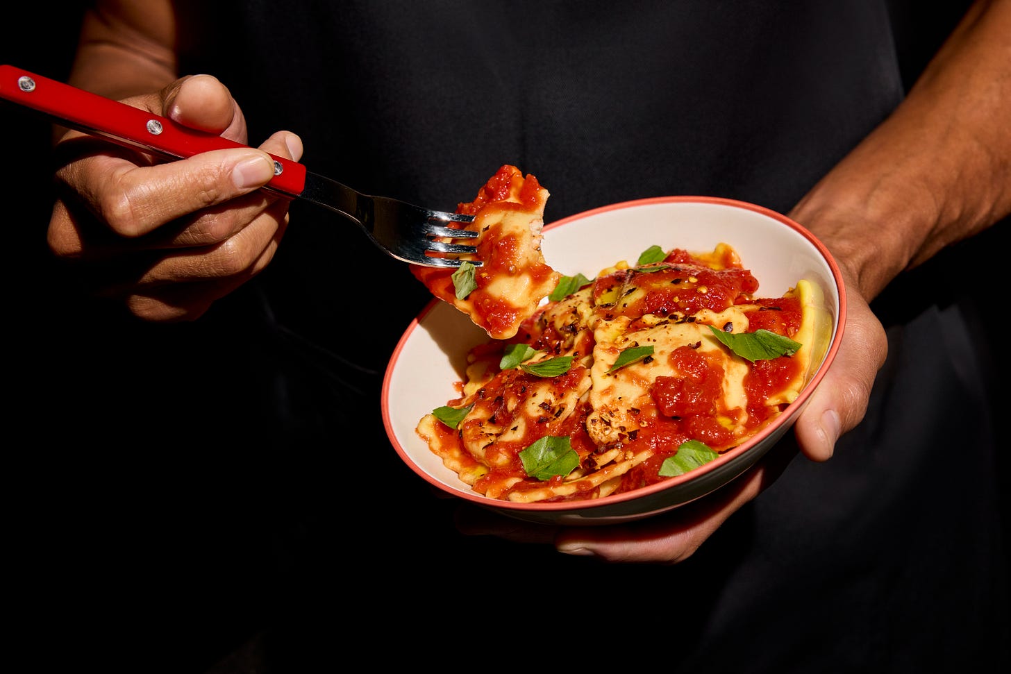 a bowl of Ripi ravioli with sauce and basil