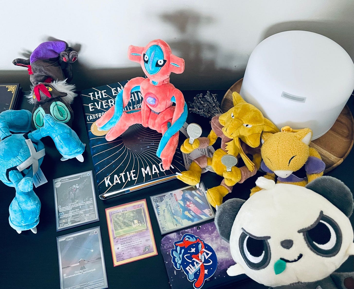 Ze Colonel’s collection of Pokémon items, including plush toys of Deoxys, Alakazam, and Metagross