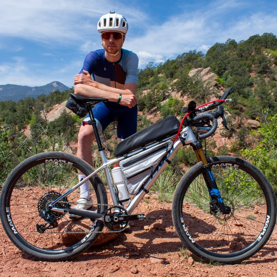 Pivot Les SL bike in a drop bar build with a person behind it