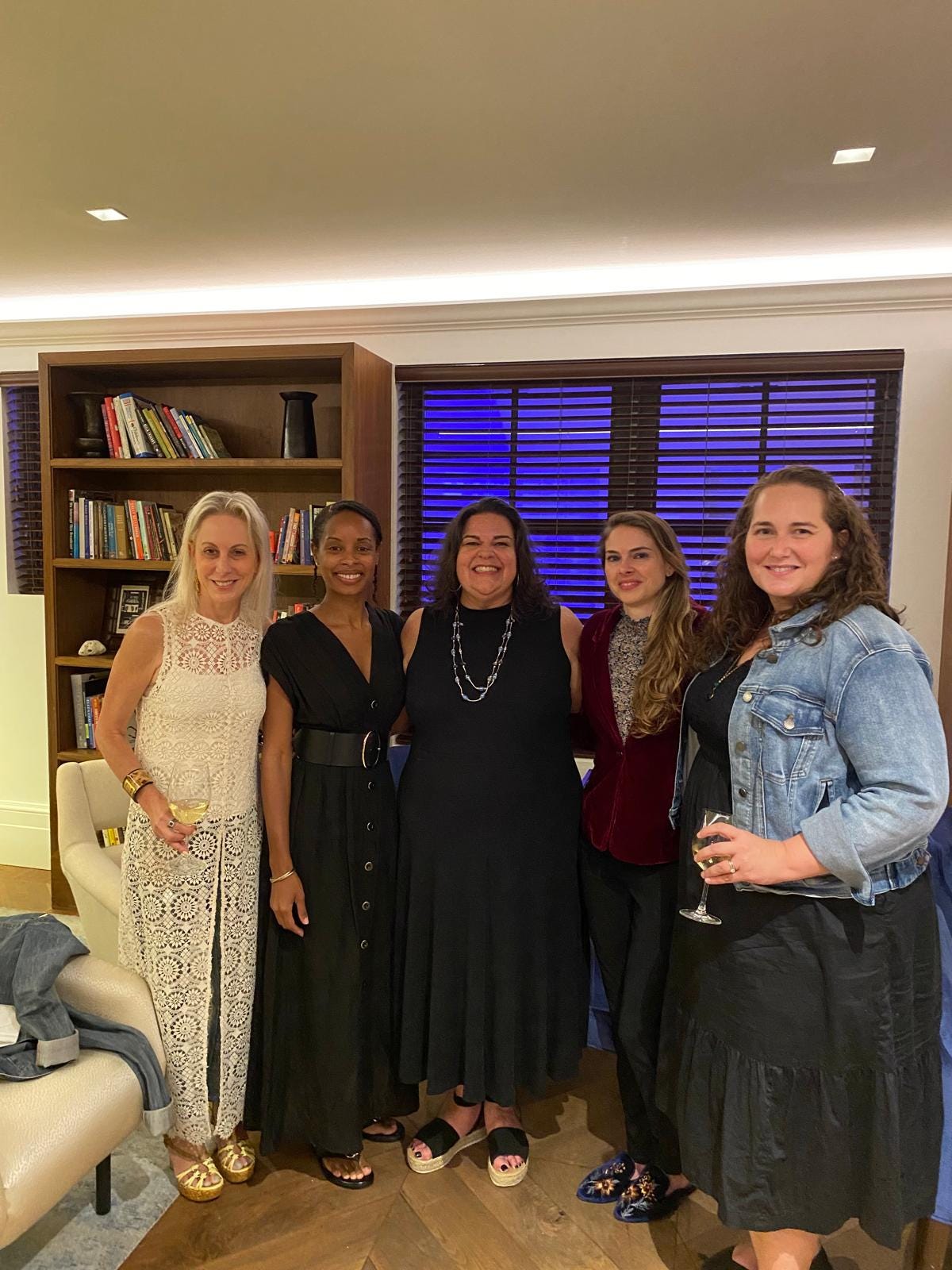 From left: Jen Karetnick, Nicole Sealey, Caridad Moro-Gronlier, Nicole Tallman, Mary Block stand in a library, smiling.