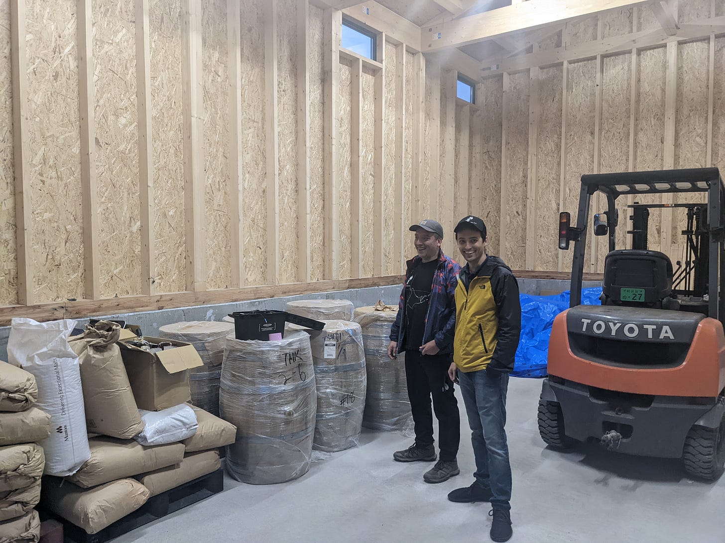 Javier and Jordan standing in empty warehouse space envisioning future barrel storage at Kamui Whisky K.K.
