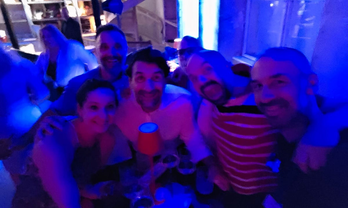 Partying people in blue light, Annya with friends