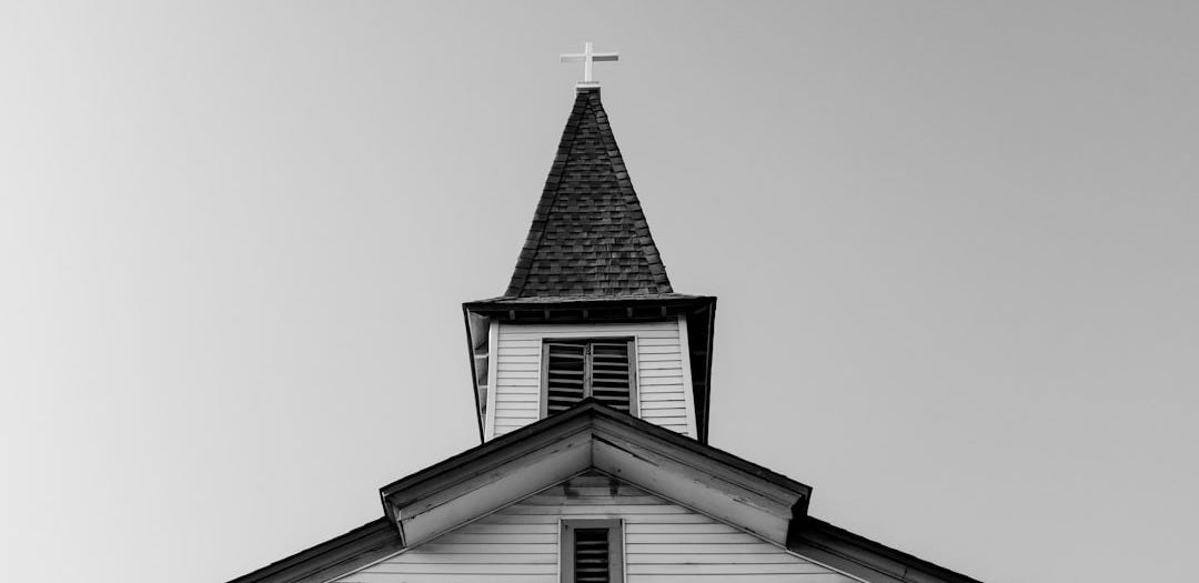 white and black concrete chapel in low angle photography