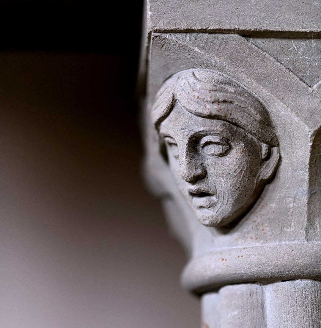 white concrete statue of man