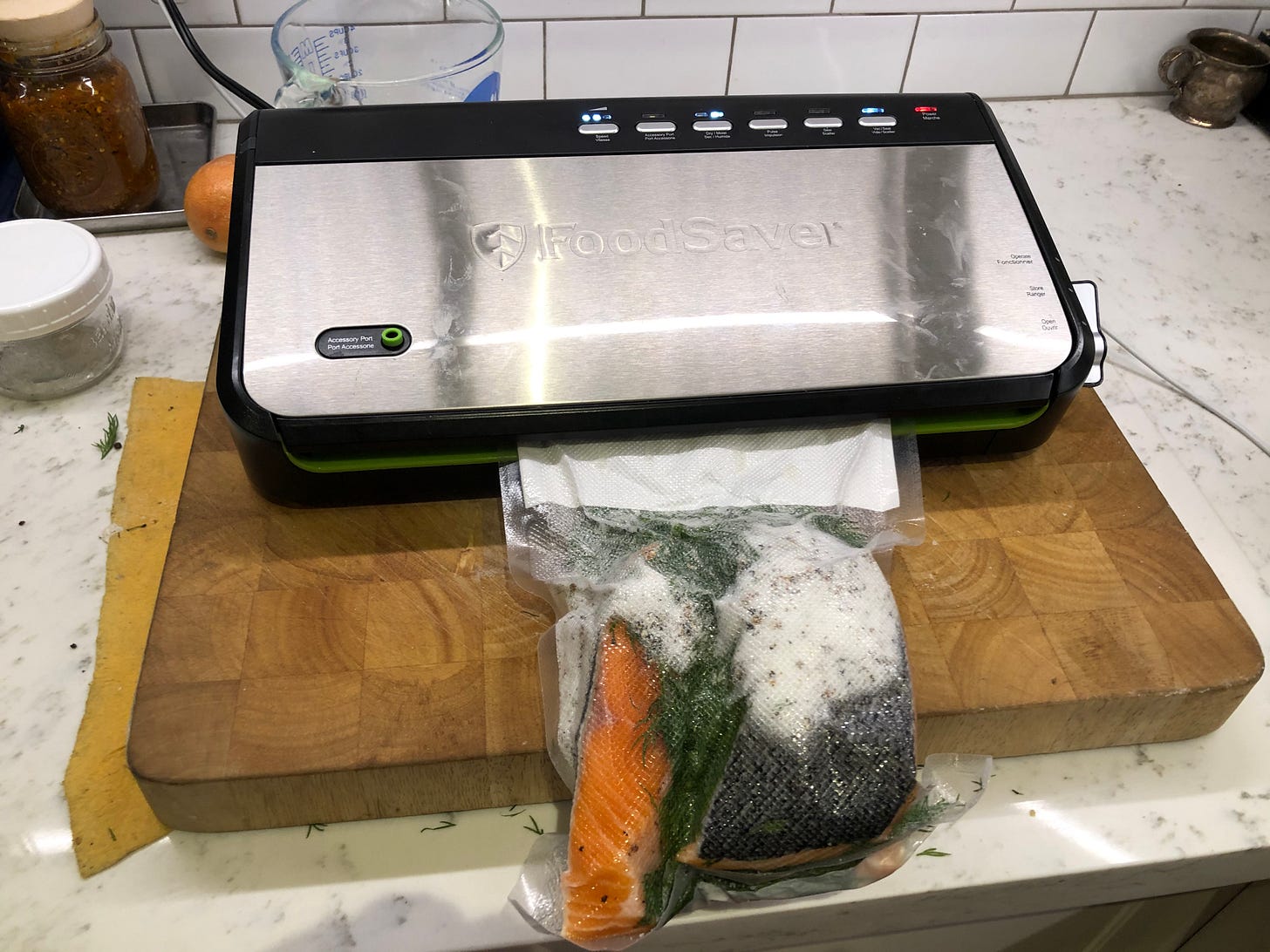 The assembled gravlax being vacuum sealed.