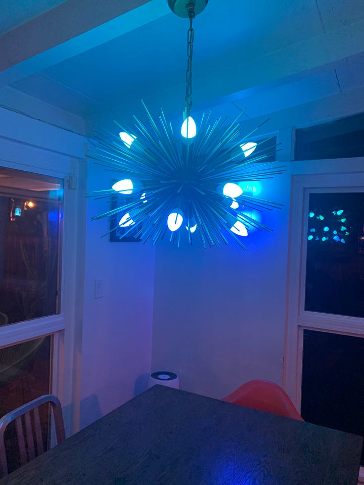 Caissie’s Sputnik chandelier with white bulbs, then pink bulbs, then blue bulbs, then multicolored bulbs.