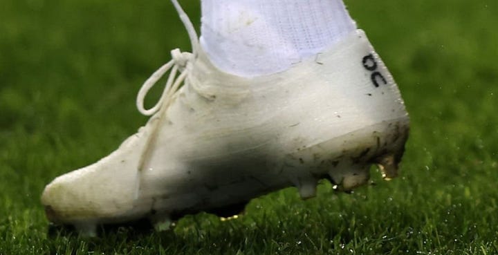 Kylian Mbappé warming up for France in white On LightSpray prototype boots marked ON-DCPT-KM010, and a close-up of the On logo on the boot's heel