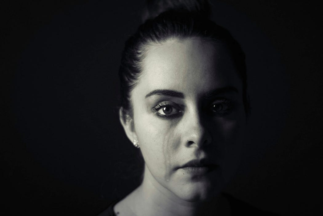 Woman crying with black background