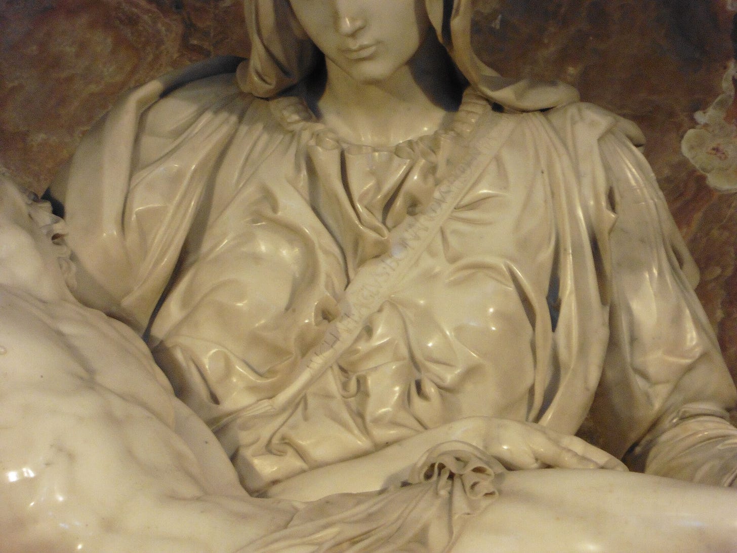 The band across the Virgin's chest, with the line of Latin cut into it one night