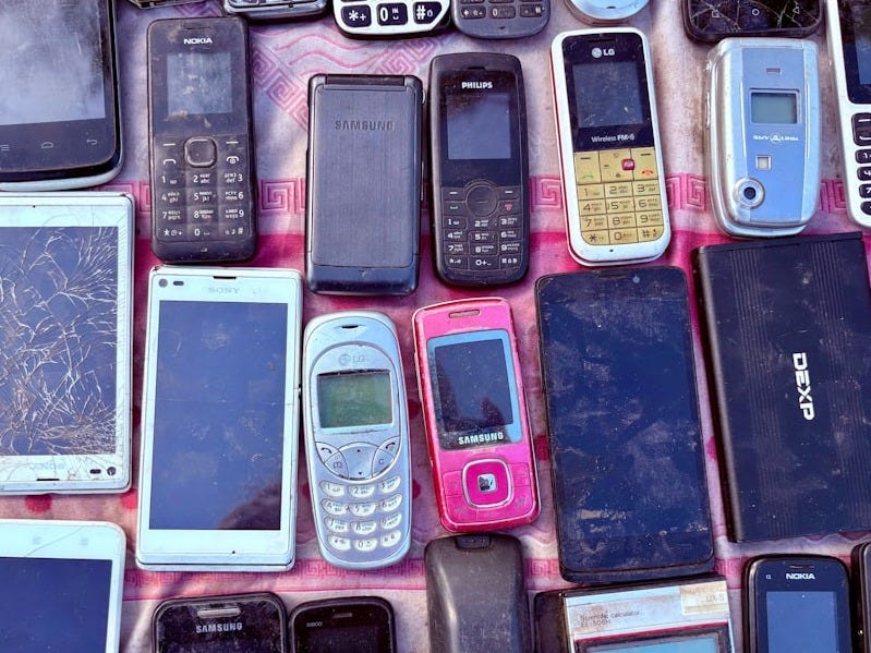 A collection of various old mobile phones and devices. A collection of various old mobile phones and devices.