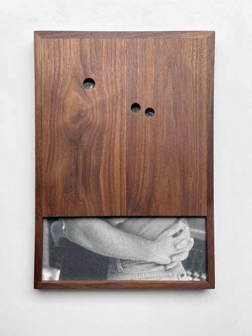 This may contain: a wooden frame with two holes in it