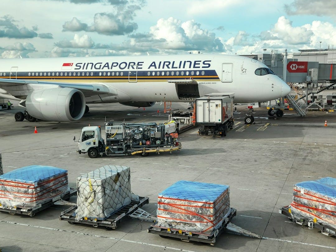 A large jetliner sitting on top of an airport tarmac