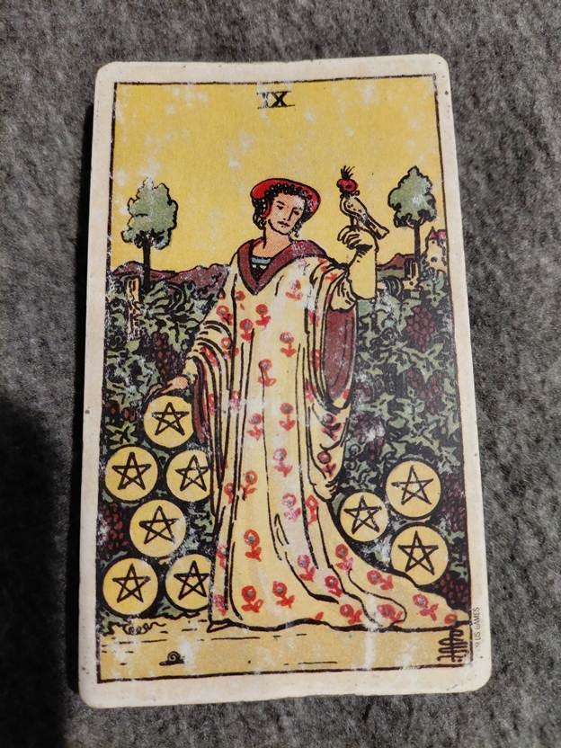 A tarot card with a person in a robe
