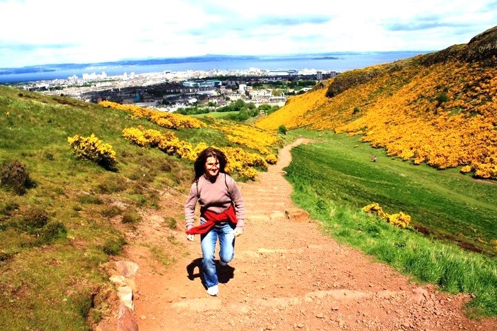 A woman hiking up a dirt path