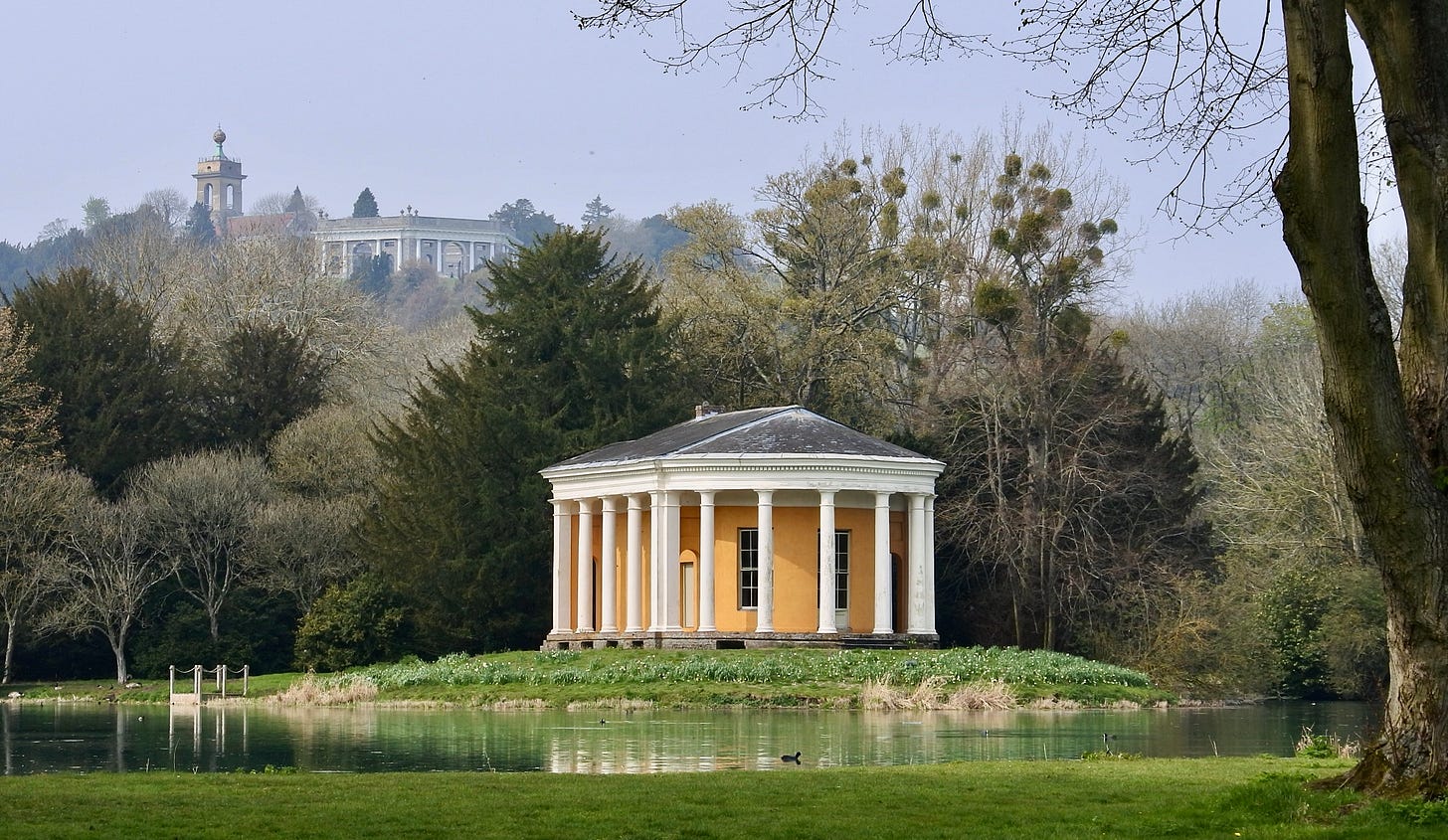 The "Temple of Music" situated on one of the islands of the swan-shaped lake. In the background, on the hill, are the Dashwood mausoleum and church. The "Temple of Music" situated on one of the islands of the swan-shaped lake. In the background, on the hill, are the Dashwood mausoleum and church.
