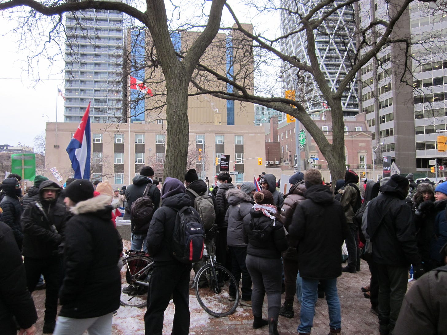 A group of protestors at a street junction across from the US Consulate, carrying signs and various flags. Those of Venezuela, Cuba, and Palestine were seen. A group of protestors at a street junction across from the US Consulate, carrying signs and various flags. Those of Venezuela, Cuba, and Palestine were seen.