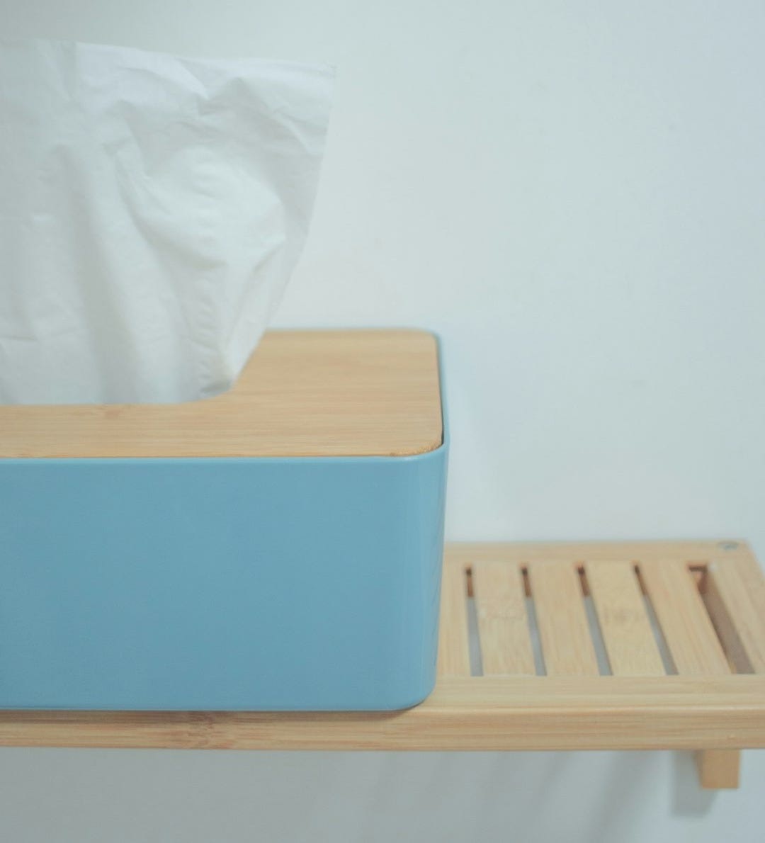 white tissue paper on blue plastic trash bin white tissue paper on blue plastic trash bin