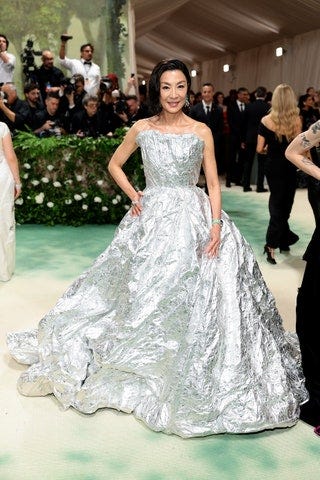 Image may contain Michelle Yeoh Clothing Dress Adult Person Footwear High Heel Shoe Fashion Formal Wear and Gown