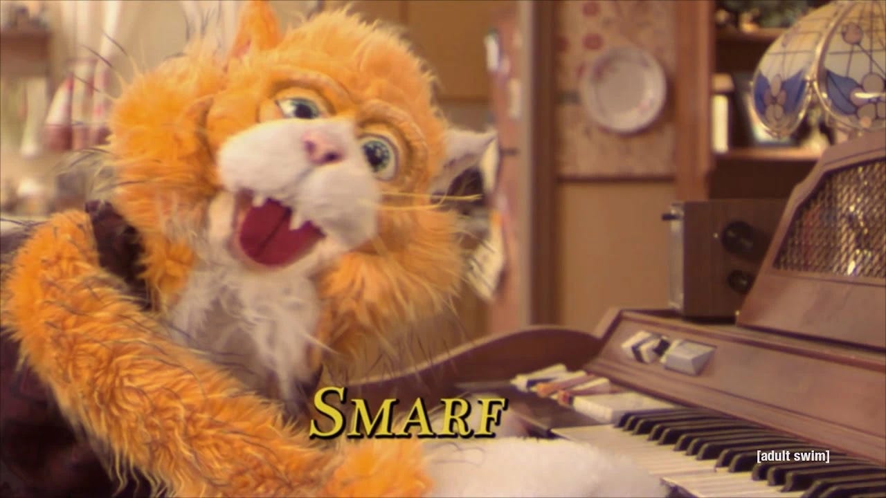 Smarf, the orange cat puppet from Too Many Cooks.