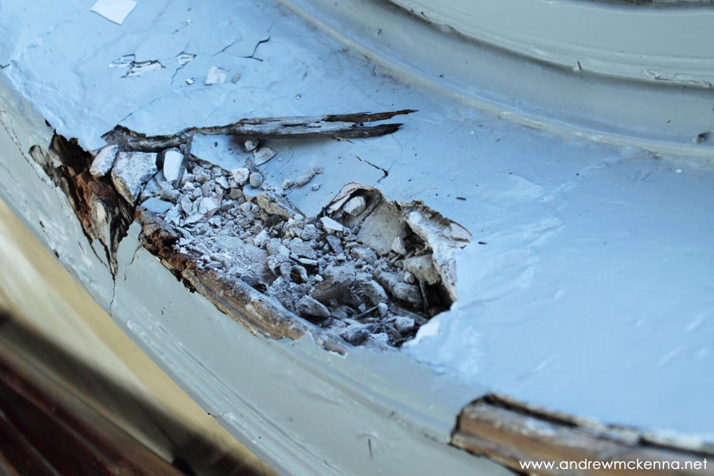 Crumbling plasterwork on a windo ledge