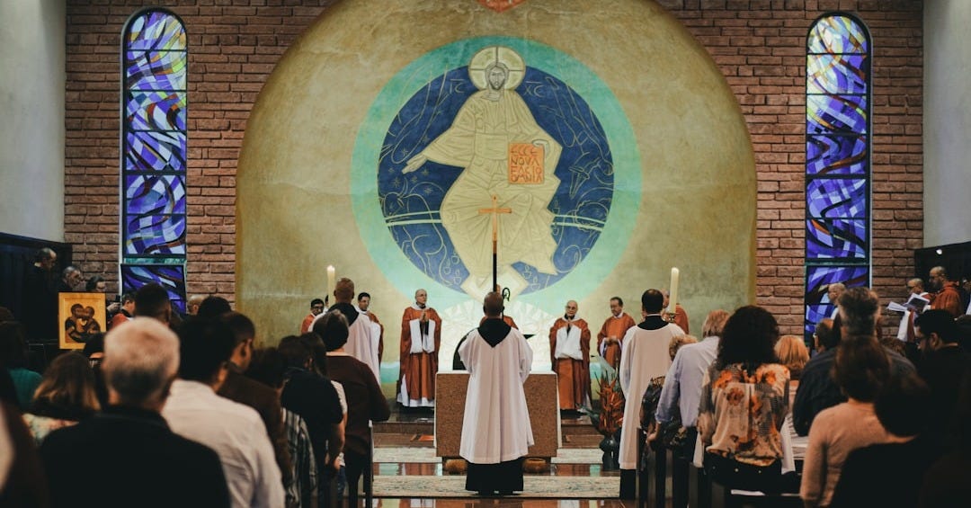 priest beside people in church priest beside people in church