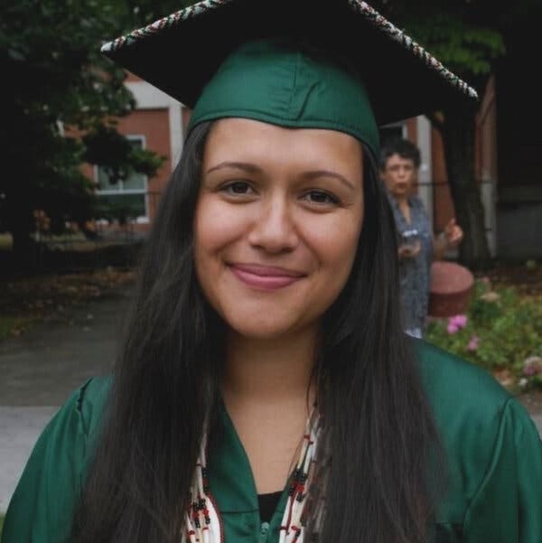Emmilee Risling in cap and gown after graduating from the University of Oregon. 