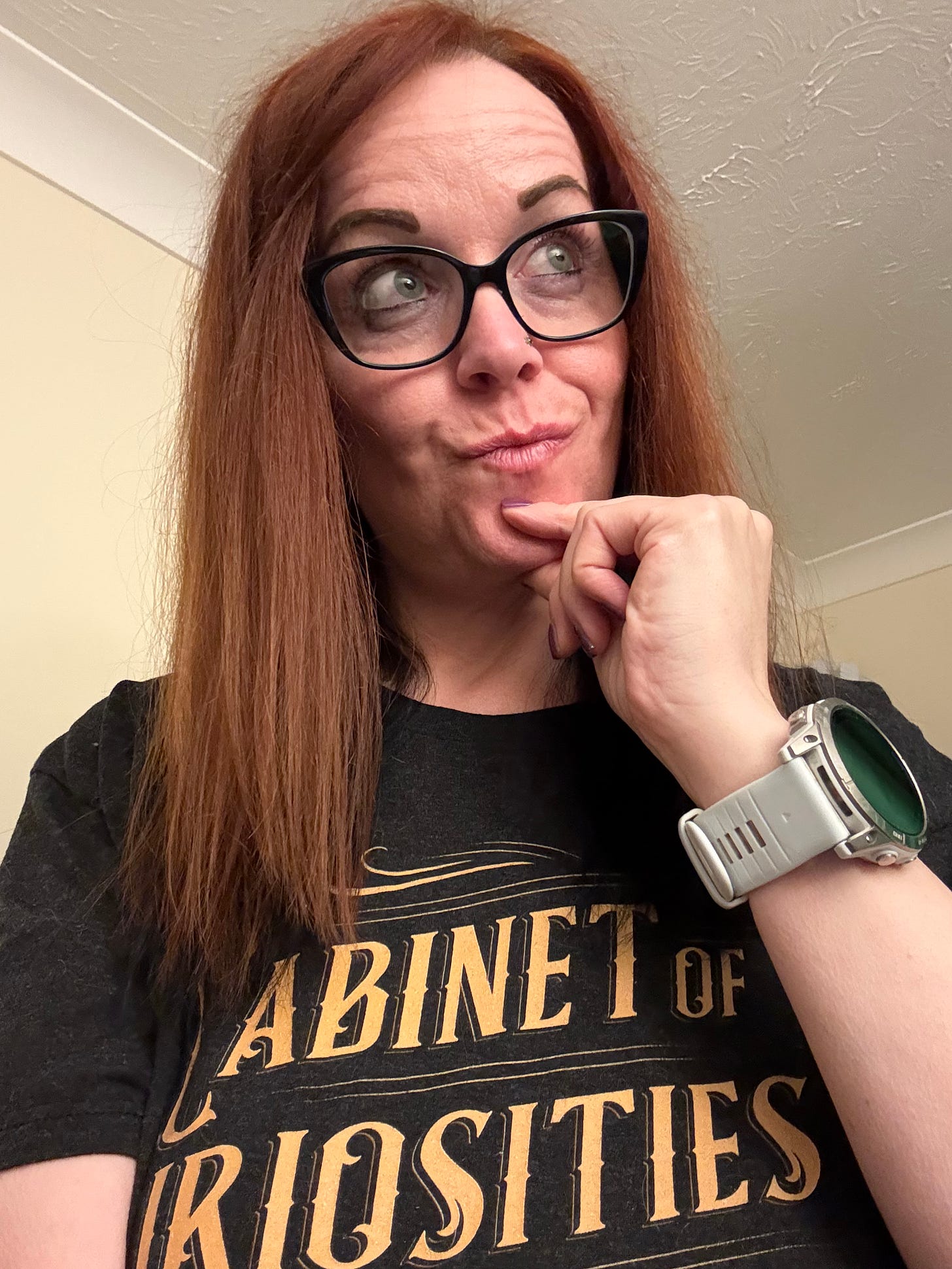 Georgina Dean smiles warmly, holding up a bright red coffee mug that says "STRONGER THAN YOU THINK" in gold letters, symbolizing creative resilience and overcoming self-doubt.