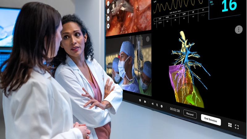 Two female surgeons using AI for an advanced medical procedure Two female surgeons using AI for an advanced medical procedure