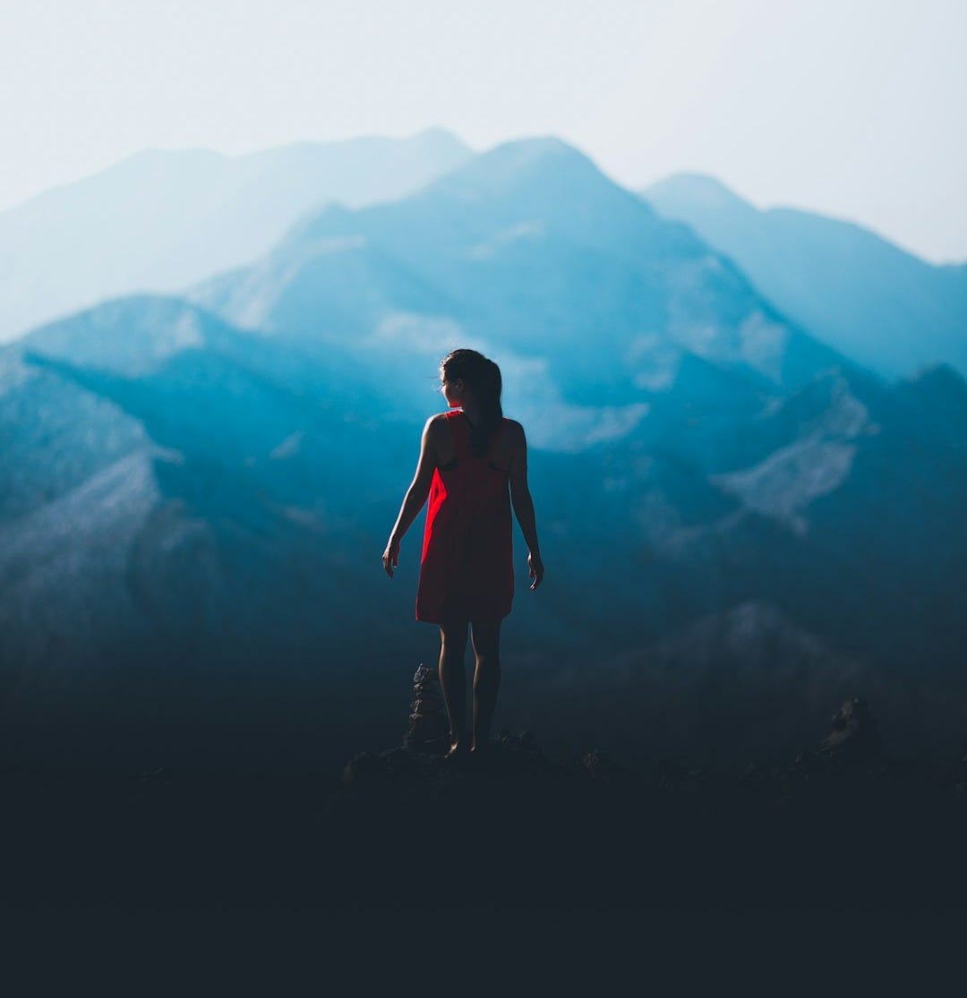 woman standing in front of mountain woman standing in front of mountain