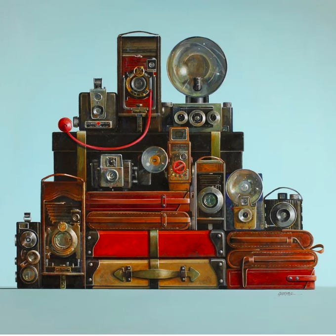A stack of cameras and suitcases

Description automatically generated