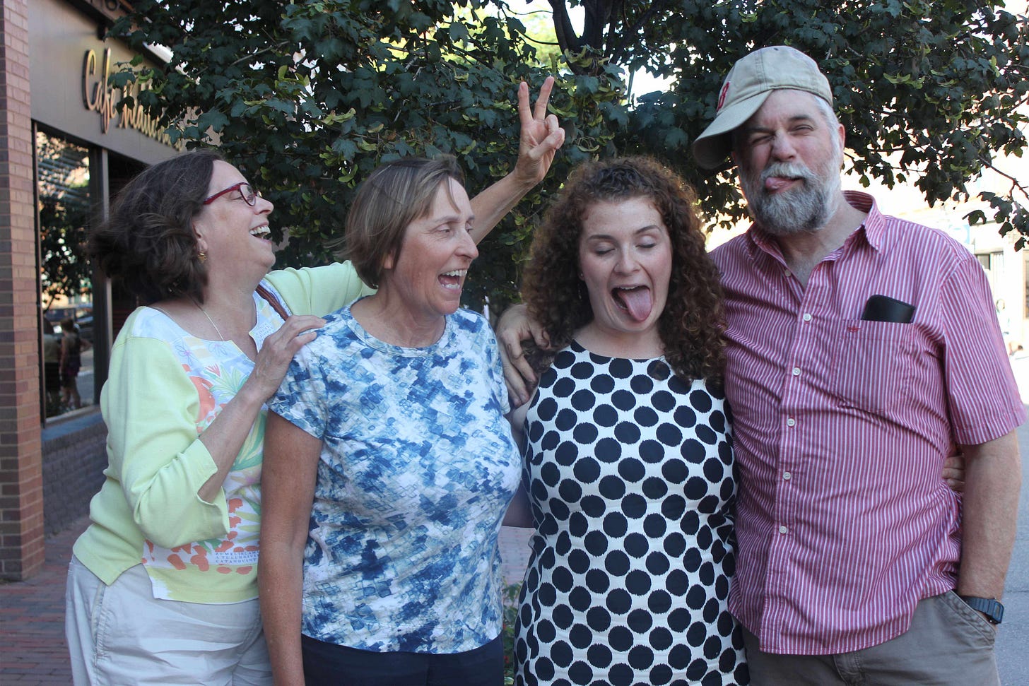Uncle Kevin, Aunt Em, Sarah (Aunt Em's sister), and me with goofy faces post outside before my graduate school graduation in New Hampshire