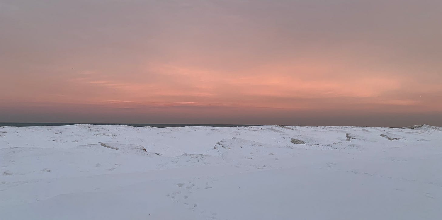 wintry sunset over lake michigan, with just a sliver of water showing and a lot of ice wintry sunset over lake michigan, with just a sliver of water showing and a lot of ice